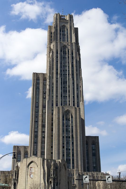 The Gothic Revival tower of the University of Pittsburgh's Cathedral of Learning against a blue sky